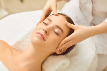 Face massage close up. Beautiful girl has a facial massage in a beauty clinic.